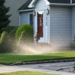 lawn sprinkler in front of a house